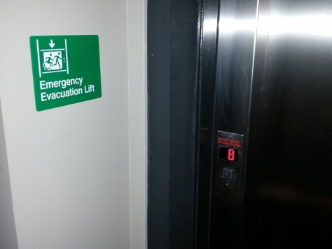 Braille Sign Supplies Emergency Evacuation Lift Sign on Wall, next to lift doors